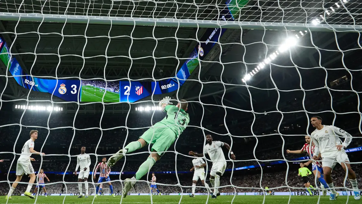 MADRID, SPAIN - MARCH 22: Andriy Lunin of Real Madrid dives for a save during the LaLiga EA Sports match between Real Madrid CF and Atletico de Madrid at Estadio Santiago Bernabeu on March 22, 2026 in Madrid, Spain. (Photo by Angel Martinez/Getty Images)