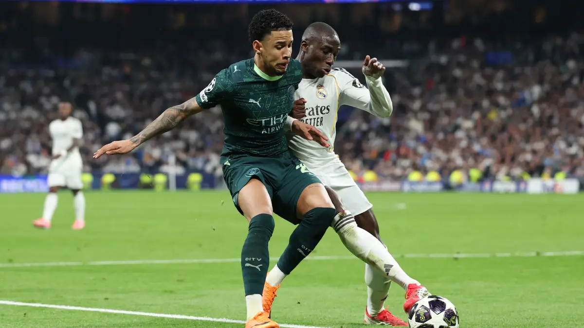 MADRID, SPAIN - MARCH 11: Savinho of Manchester City is challenged by Ferland Mendy of Real Madrid during the UEFA Champions League 2025/26 Round of 16 First Leg match between Real Madrid CF and Manchester City FC at Estadio Santiago Bernabeu on March 11, 2026 in Madrid, Spain. (Photo by Florencia Tan Jun/Getty Images)