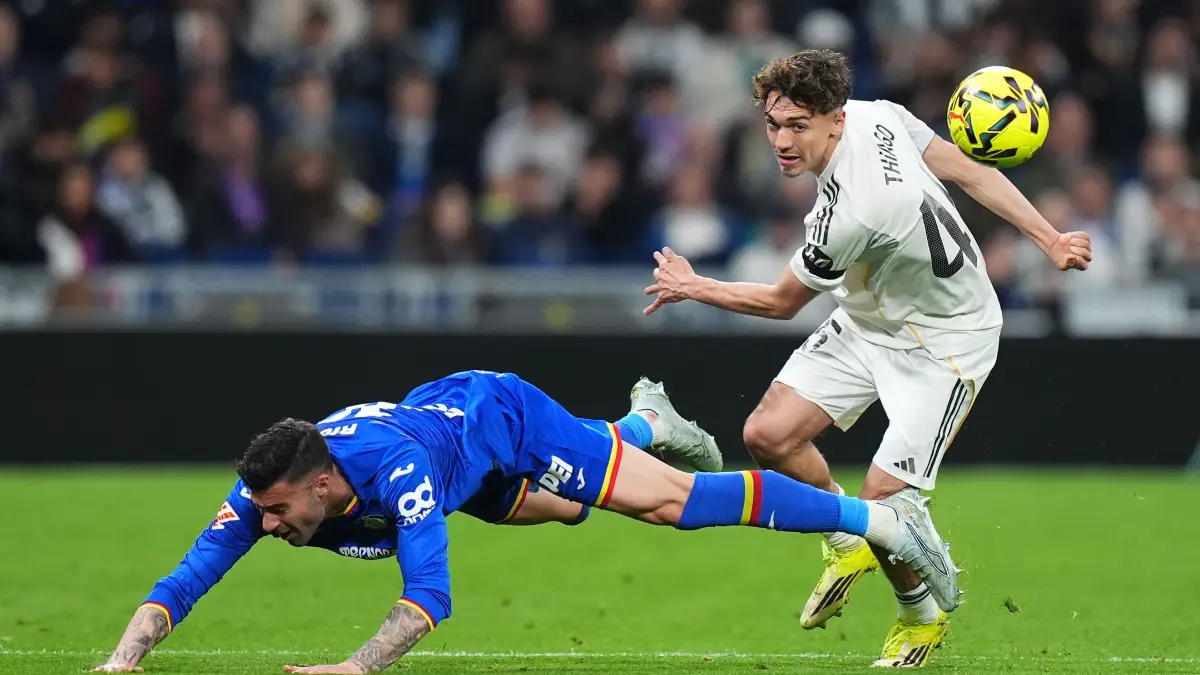 MADRID, SPAIN - MARCH 02: Thiago Pitarch of Real Madrid is challenged by Diego Rico of Getafe during the LaLiga EA Sports match between Real Madrid CF and Getafe CF at Estadio Santiago Bernabeu on March 02, 2026 in Madrid, Spain. (Photo by Angel Martinez/Getty Images)