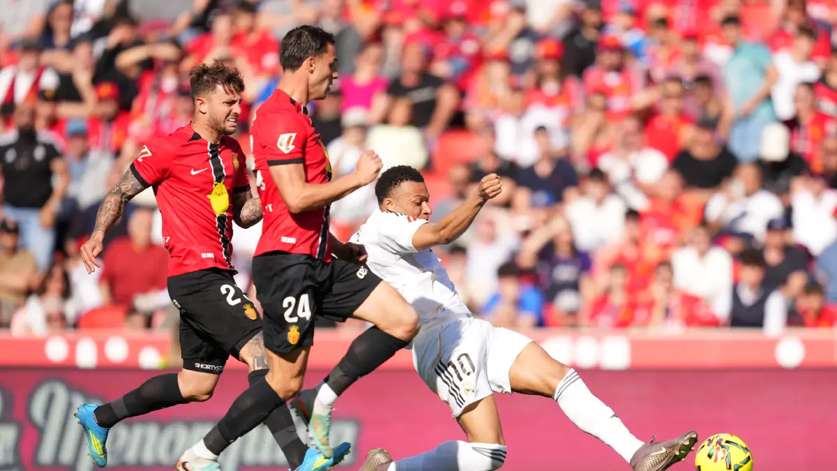 MALLORCA, SPAIN - APRIL 04: Kylian Mbappe of Real Madrid is challenged by Pablo Maffeo and Martin Valjent of RCD Mallorca during the LaLiga EA Sports match between RCD Mallorca and Real Madrid CF at Estadio Daredevil Son Moix on April 04, 2026 in Mallorca, Spain. (Photo by Alex Caparros/Getty Images)