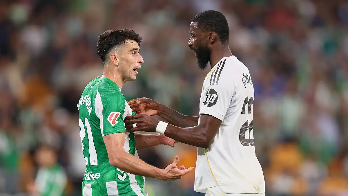 SEVILLE, SPAIN - APRIL 24: Marc Roca of Real Betis argues with Antonio Rüdiger of Real Madrid during the LaLiga EA Sports match between Real Betis Balompie and Real Madrid CF at Estadio La Cartuja on April 24, 2026 in Seville, Spain. (Photo by Fran Santiago/Getty Images)