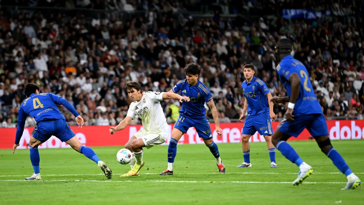 MADRID, SPAIN - MAY 14: Gonzalo Garcia of Real Madrid is challenged by David Costas and Santiago Colombatto of Real Oviedo during the LaLiga EA Sports match between Real Madrid CF and Real Oviedo at Estadio Santiago Bernabeu on May 14, 2026 in Madrid, Spain. (Photo by Denis Doyle/Getty Images)