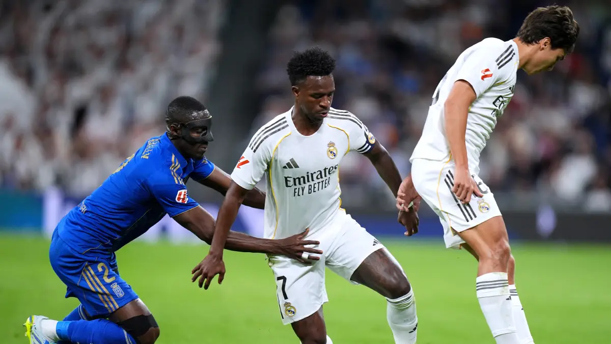 MADRID, SPAIN - MAY 14: Vinicius Junior of Real Madrid is challenged by Eric Bailly of Real Oviedo during the LaLiga EA Sports match between Real Madrid CF and Real Oviedo at Estadio Santiago Bernabeu on May 14, 2026 in Madrid, Spain. (Photo by Angel Martinez/Getty Images)