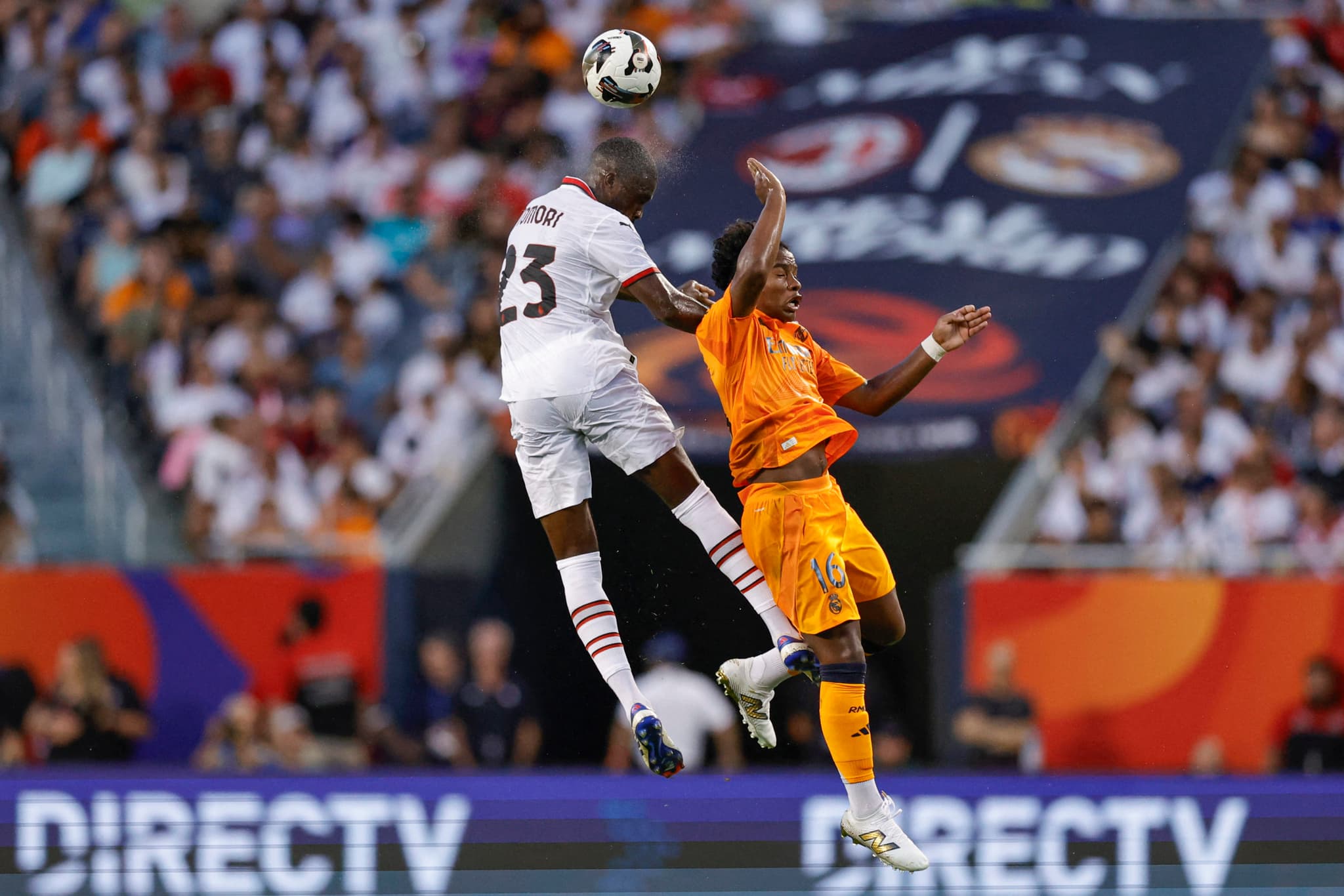 AC Milan's English defender #23 Fikayo Tomori (L) goes for a header against Real Madrid's Brazilian forward #16 Endrick (R) during the first half of pre-season club friendly football match between AC Milan and Real Madrid at Soldier Field in Chicago, Illinois, on July 31, 2024. (Photo by KAMIL KRZACZYNSKI / AFP) (Photo by KAMIL KRZACZYNSKI/AFP via Getty Images)