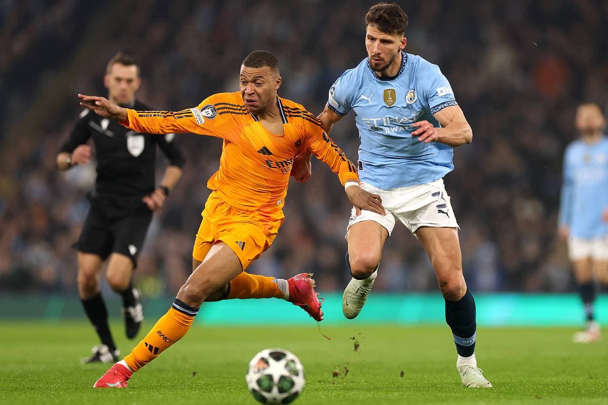 MANCHESTER, ENGLAND - FEBRUARY 11: Kylian Mbappe of Real Madrid is challenged by Ruben Dias of Manchester City during the UEFA Champions League 2024/25 League Knockout Play-off first leg match between Manchester City and Real Madrid C.F. at Manchester City Stadium on February 11, 2025 in Manchester, England. (Photo by Carl Recine/Getty Images)