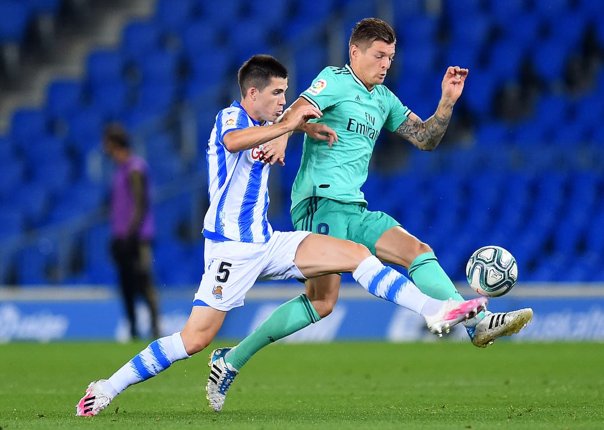 SAN SEBASTIAN, SPAIN - JUNE 21: Igor Zubeldia of Real Sociedad is tackled by Toni Kroos of Real Sociedad during the Liga match between Real Sociedad and Real Madrid CF at Estadio Anoeta on June 21, 2020 in San Sebastian, Spain. (Photo by Juan Manuel Serrano Arce/Getty Images)