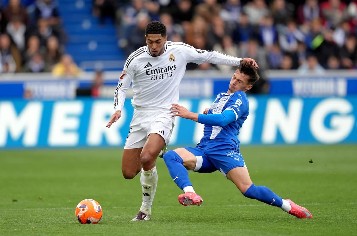 VITORIA-GASTEIZ, SPAIN - APRIL 13: Jude Bellingham of Real Madrid is challenged by Carlos Martin of Deportivo Alaves during the LaLiga match between Deportivo Alaves and Real Madrid CF at Estadio de Mendizorroza on April 13, 2025 in Vitoria-Gasteiz, Spain. (Photo by Juan Manuel Serrano Arce/Getty Images)