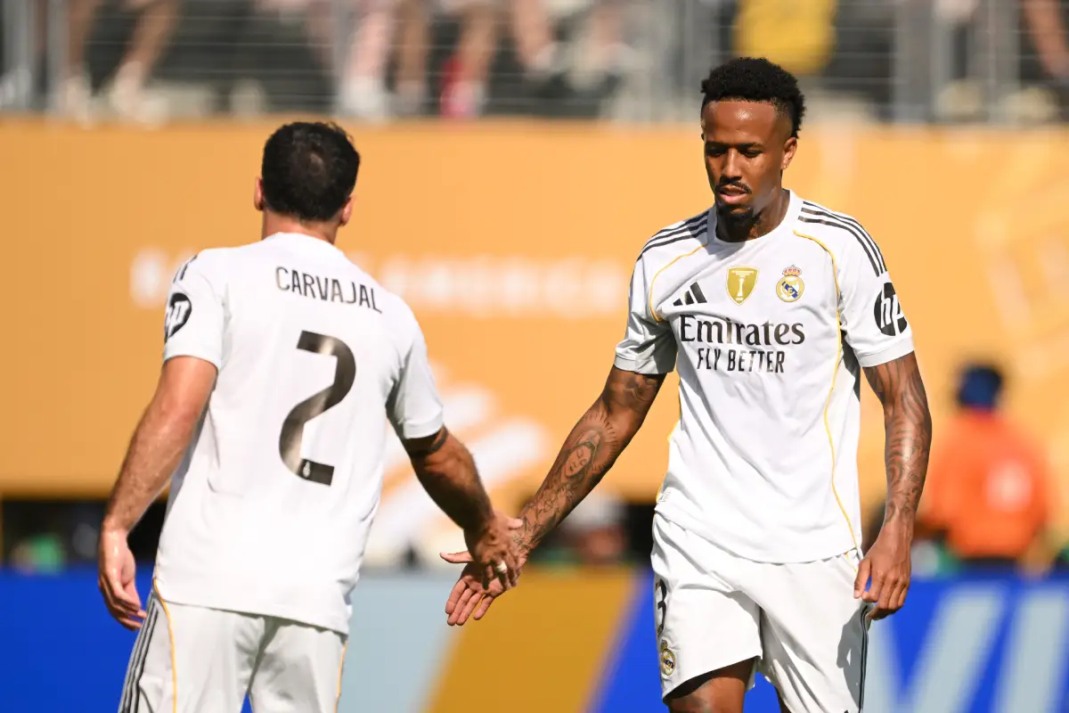 EAST RUTHERFORD, NEW JERSEY - JULY 09: Eder Militao #3 of Real Madrid C.F. shakes hands with teammate Dani Carvajal #2 during the FIFA Club World Cup 2025 semi-final match between Paris Saint-Germain and Real Madrid CF at MetLife Stadium on July 09, 2025 in East Rutherford, New Jersey. (Photo by David Ramos/Getty Images)