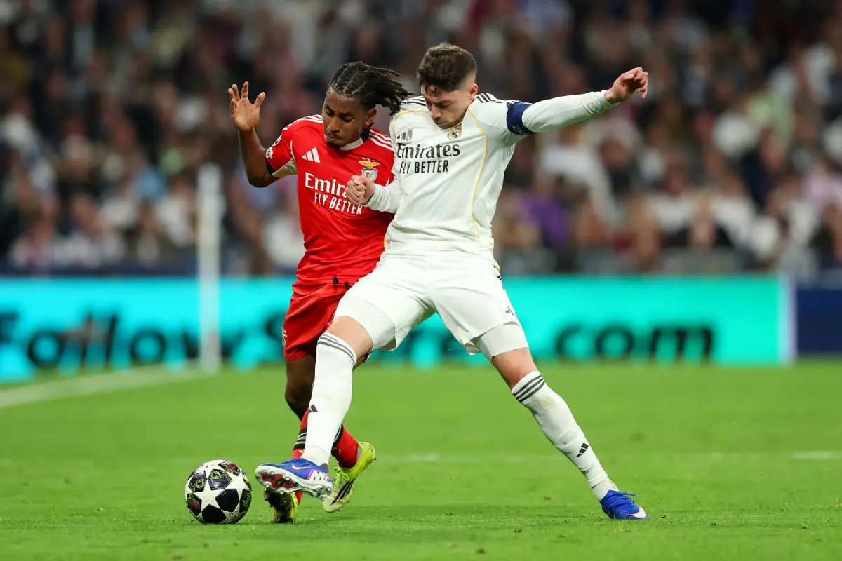 MADRID, SPAIN - FEBRUARY 25: Leandro Barreiro of Benfica is challenged by Federico Valverde of Real Madrid during the UEFA Champions League 2025/26 League Knockout Play-off Second Leg match between Real Madrid C.F. and SL Benfica at Estadio Santiago Bernabeu on February 25, 2026 in Madrid, Spain. (Photo by Clive Brunskill/Getty Images)