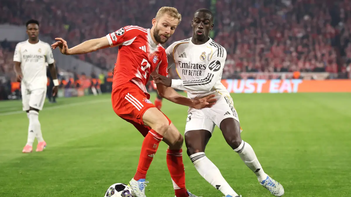 MUNICH, GERMANY - APRIL 15: Konrad Laimer of FC Bayern Munich is challenged by Ferland Mendy of Real Madrid during the UEFA Champions League 2025/26 Quarter-Final Second Leg match between FC Bayern München and Real Madrid CF at Football Arena Munich on April 15, 2026 in Munich, Germany. (Photo by Alex Grimm/Getty Images)