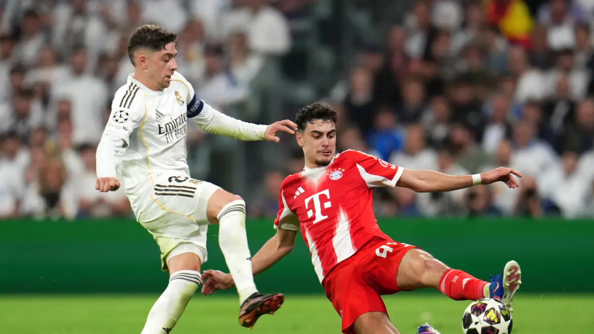 MADRID, SPAIN - APRIL 07: Aleksandar Pavlovic of FC Bayern Munich is challenged by Federico Valverde of Real Madrid during the UEFA Champions League 2025/26 Quarter-Final First Leg match between Real Madrid CF and FC Bayern München at Estadio Santiago Bernabeu on April 07, 2026 in Madrid, Spain. (Photo by Aitor Alcalde/Getty Images)