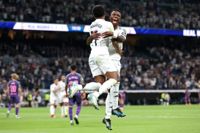 Real Madrid CF v RCD Espanyol de Barcelona - La Liga EA Sports MADRID, SPAIN - SEPTEMBER 21: Rodrygo of Real Madrid celebrates with teammate Vinicius Junior after scoring his team's second goal during the LaLiga match between Real Madrid CF and RCD Espanyol de Barcelona at Estadio Santiago Bernabeu on September 21, 2024 in Madrid, Spain. (Photo by Florencia Tan Jun/Getty Images)