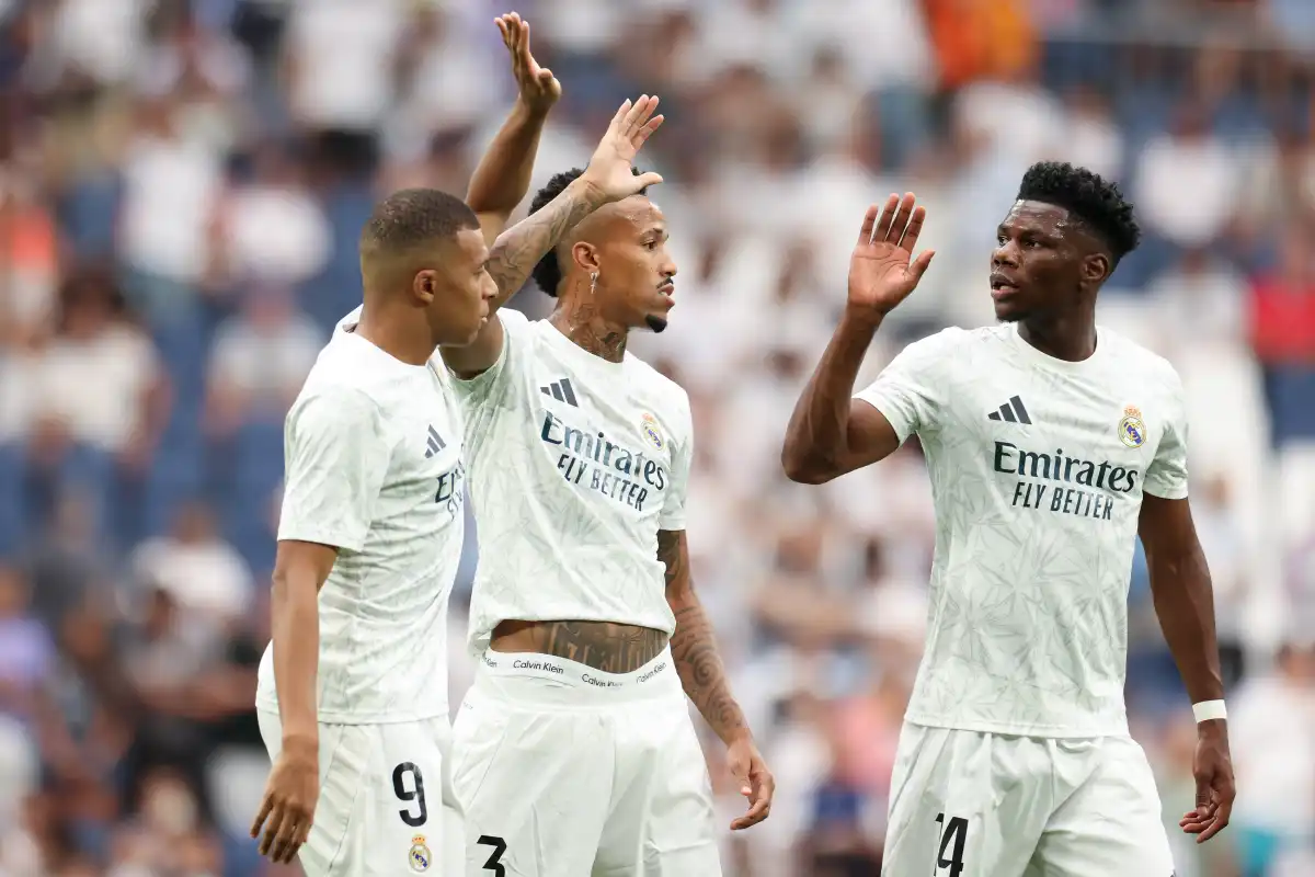 MADRID, SPAIN - AUGUST 25: Kylian Mbappe of Real Madrid CF interacts with teammates Eder Militao and Aurelien Tchouameni during the La Liga match between Real Madrid CF and Real Valladolid CF at Estadio Santiago Bernabeu on August 25, 2024 in Madrid, Spain. (Photo by Florencia Tan Jun/Getty Images)