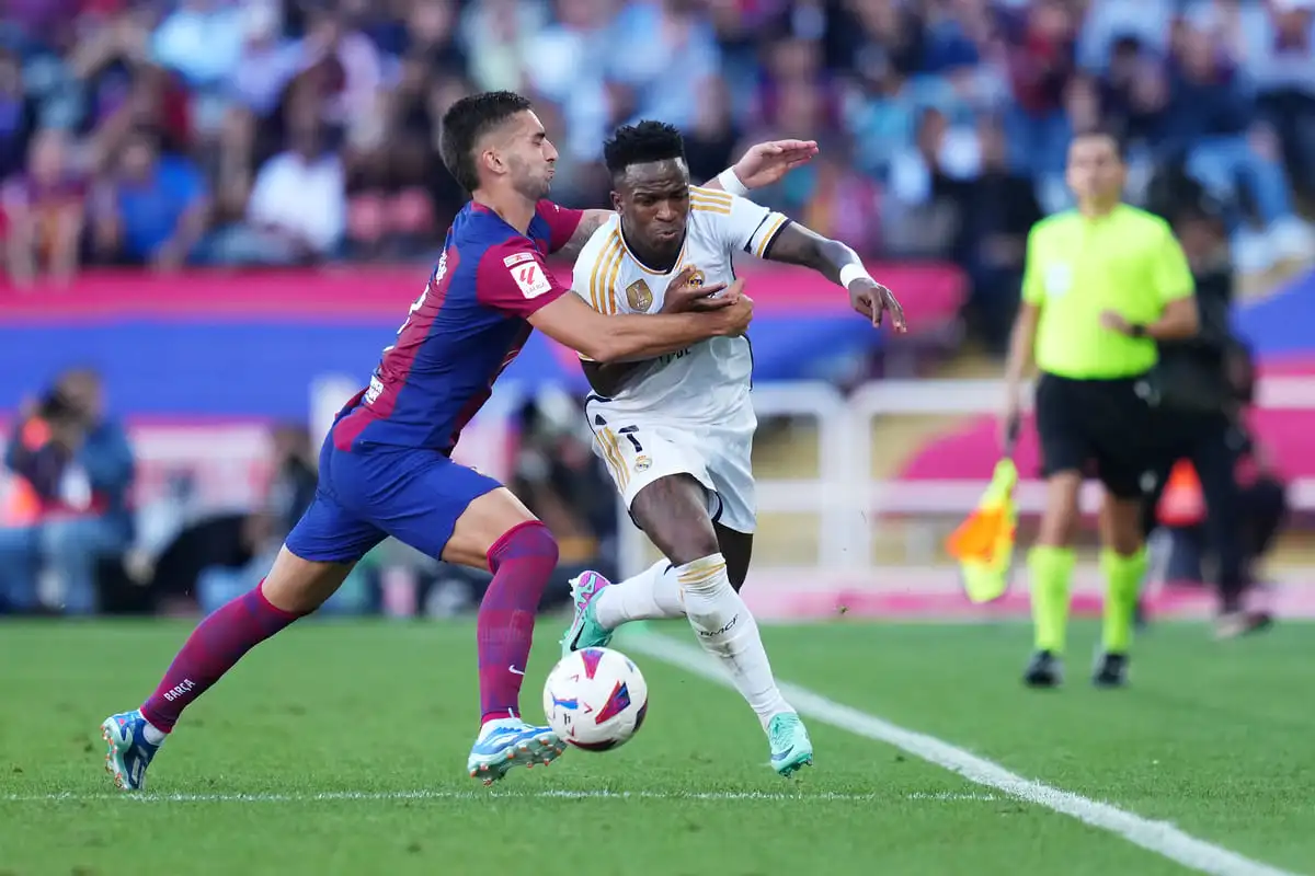 BARCELONA, SPAIN - OCTOBER 28: Vinicius Junior of Real Madrid and Ferran Torres of FC Barcelona battle for the ball during the LaLiga EA Sports match between FC Barcelona and Real Madrid CF at Estadi Olimpic Lluis Companys on October 28, 2023 in Barcelona, Spain. (Photo by Alex Caparros/Getty Images).