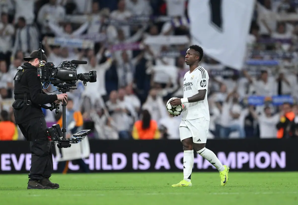 MADRID, SPAIN - OCTOBER 22: Vinicius Junior of Real Madrid collects the match ball at full-time having scored a hat-trick following the team's victory in the UEFA Champions League 2024/25 League Phase MD3 match between Real Madrid C.F. and Borussia Dortmund at Estadio Santiago Bernabeu on October 22, 2024 in Madrid, Spain. (Photo by David Ramos/Getty Images)