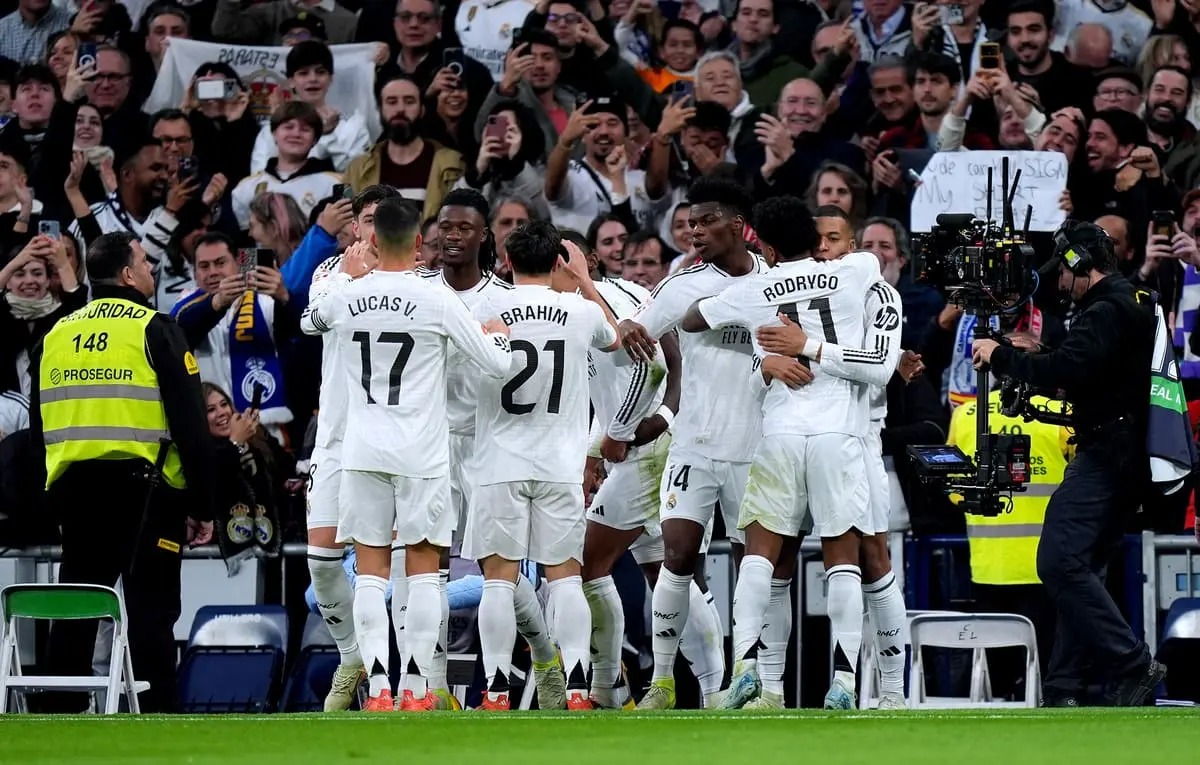MADRID, SPAIN - DECEMBER 22: Kylian Mbappe of Real Madrid celebrates with teammates after scoring his sides first goal during the LaLiga match between Real Madrid CF and Sevilla FC at Estadio Santiago Bernabeu on December 22, 2024 in Madrid, Spain. (Photo by Angel Martinez/Getty Images)