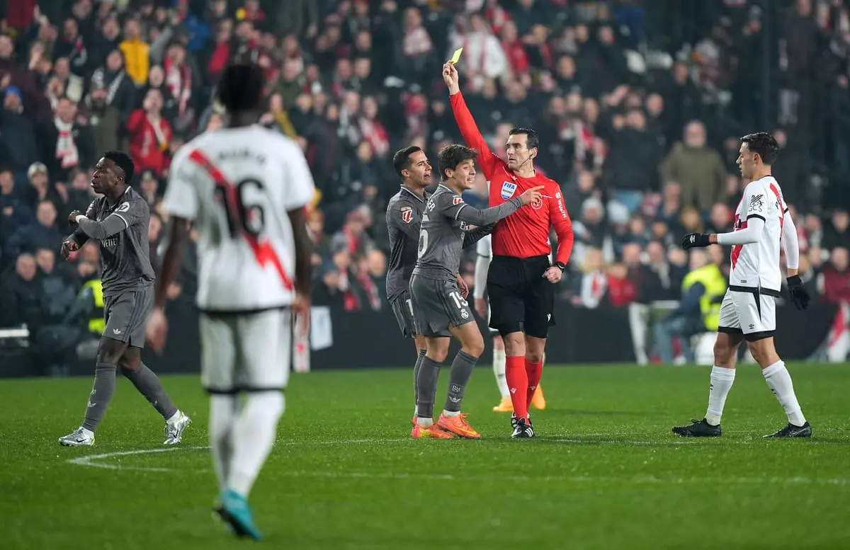 Vinicius Jr of Real Madrid reacts as he is shown a yellow card by referee Juan Martinez Munuera during the LaLiga EA Sports match between Rayo Vallecano and Real Madrid at Estadio de Vallecas on December 14, 2024 in Madrid, Spain. (Photo by Angel Martinez/Getty Images)
