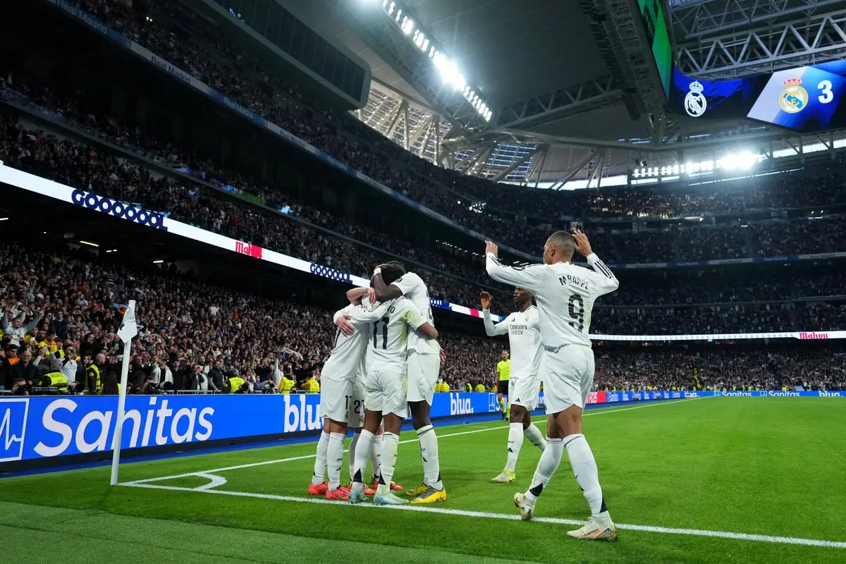 MADRID, SPAIN - DECEMBER 22: Rodrygo of Real Madrid is congratulated by teammates after scoring his sides third goal during the LaLiga match between Real Madrid CF and Sevilla FC at Estadio Santiago Bernabeu on December 22, 2024 in Madrid, Spain. (Photo by Angel Martinez/Getty Images)