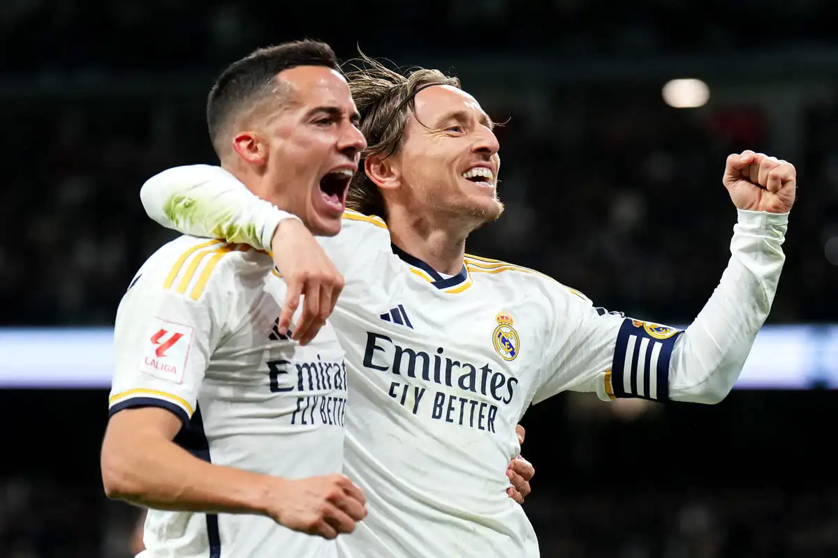 MADRID, SPAIN - FEBRUARY 25: Luka Modric of Real Madrid celebrates scoring his team's first goal with Lucas Vazquez during the LaLiga EA Sports match between Real Madrid CF and Sevilla FC at Estadio Santiago Bernabeu on February 25, 2024 in Madrid, Spain. (Photo by Angel Martinez/Getty Images)