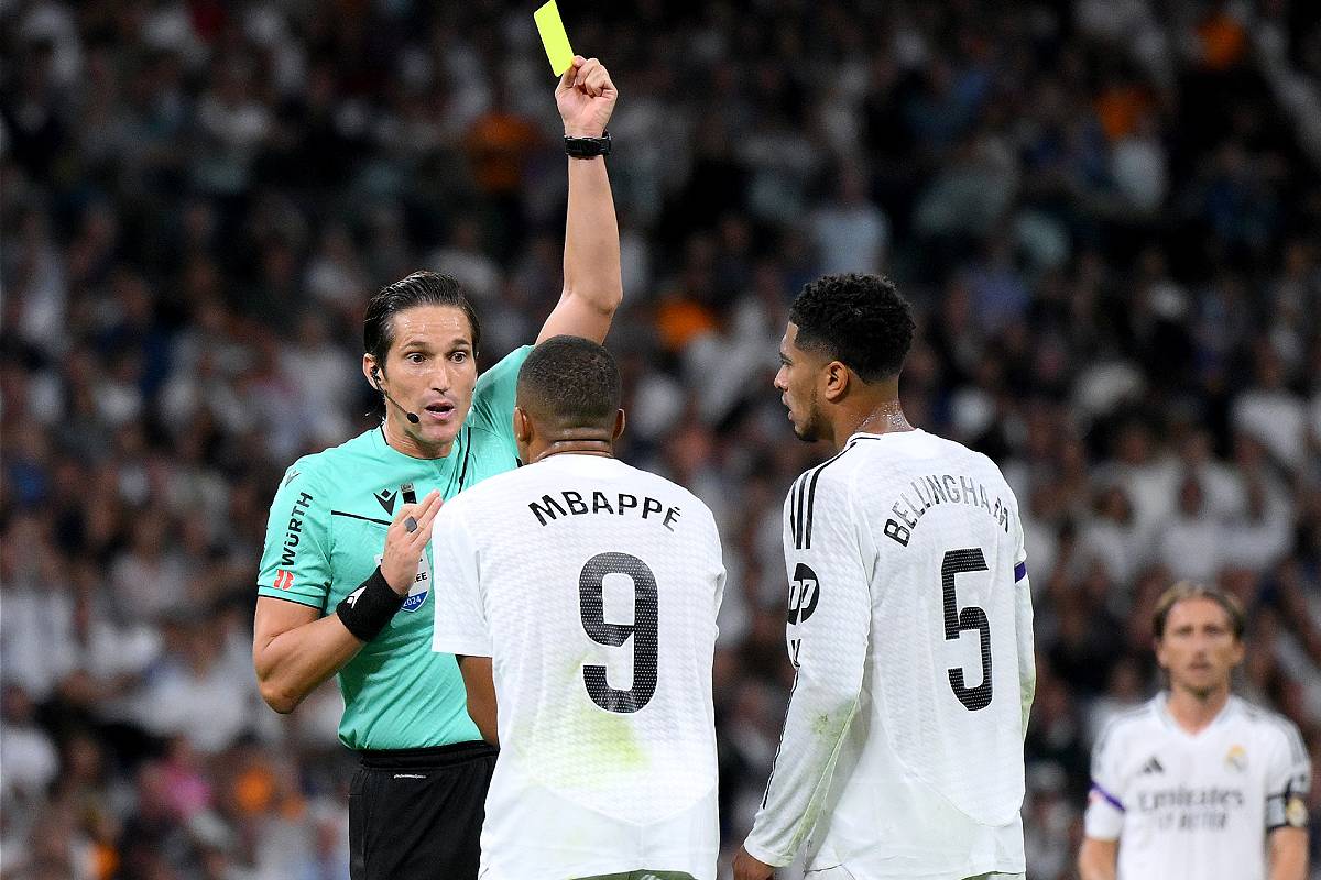 MADRID, SPAIN - SEPTEMBER 21: Kylian Mbappe of Real Madrid is shown a yellow card by Referee Jose Luis Munuera Montero during the LaLiga match between Real Madrid CF and RCD Espanyol de Barcelona at Estadio Santiago Bernabeu on September 21, 2024 in Madrid, Spain. (Photo by David Ramos/Getty Images)