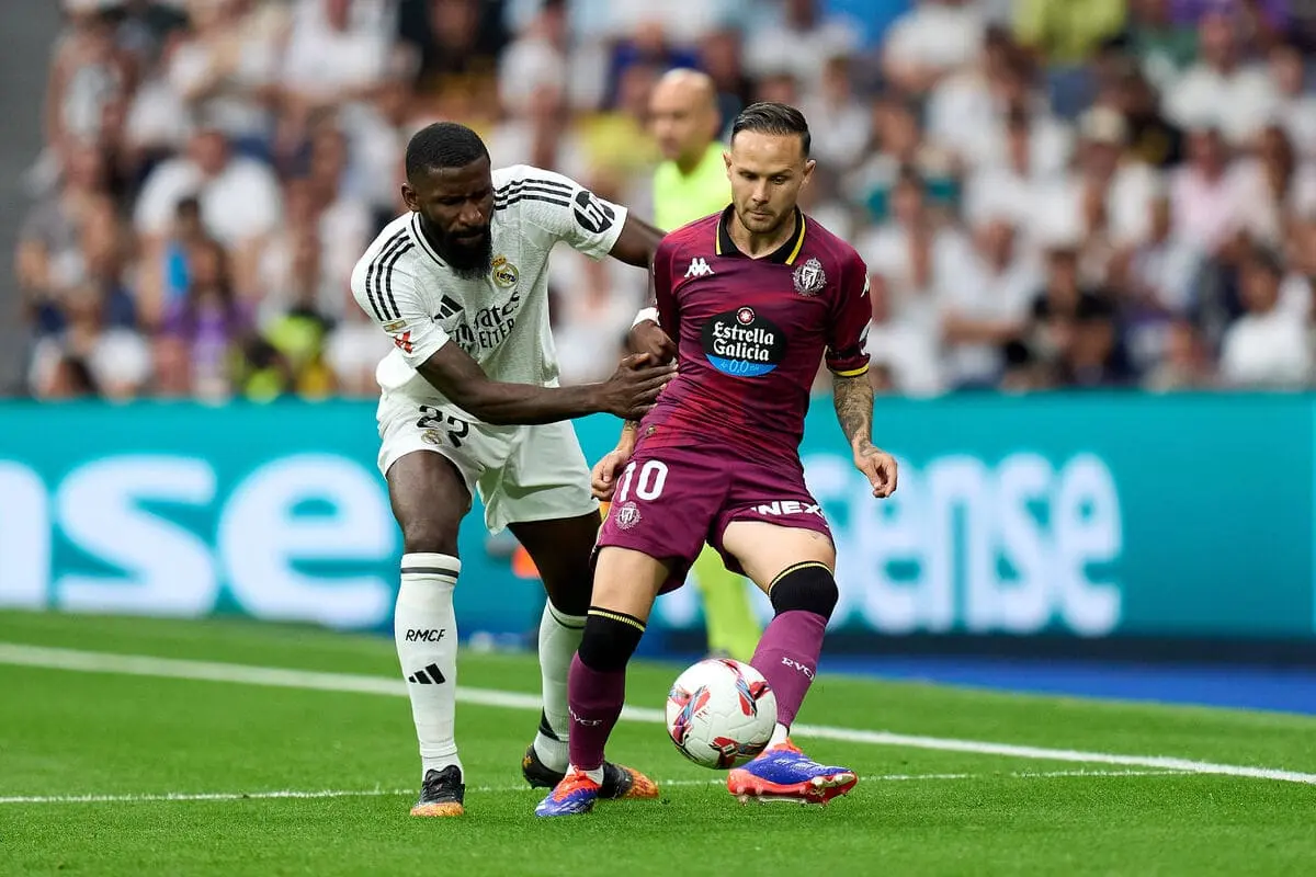 MADRID, SPAIN - AUGUST 25: Ivan Sanchez of Real Valladolid is challenged by Antonio Rudiger of Real Madrid during the La Liga match between Real Madrid CF and Real Valladolid CF at Estadio Santiago Bernabeu on August 25, 2024 in Madrid, Spain. (Photo by Angel Martinez/Getty Images).