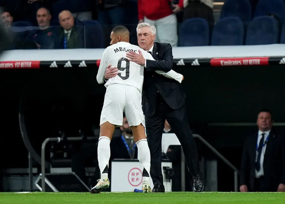 MADRID, SPAIN - DECEMBER 22: Kylian Mbappe of Real Madrid is congratulated by Carlo Ancelotti, Head Coach of Real Madrid, after he scored his team's first goal during the LaLiga match between Real Madrid CF and Sevilla FC at Estadio Santiago Bernabeu on December 22, 2024 in Madrid, Spain. (Photo by Angel Martinez/Getty Images)