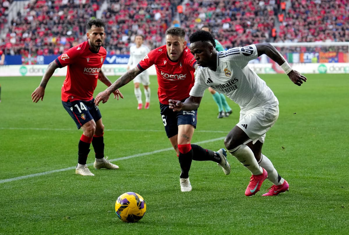 PAMPLONA, SPAIN - FEBRUARY 15: Vinicius Junior of Real Madrid battles for possession with Ruben Pena of CA Osasuna during the LaLiga match between CA Osasuna and Real Madrid CF at Estadio El Sadar on February 15, 2025 in Pamplona, Spain. (Photo by Juan Manuel Serrano Arce/Getty Images)