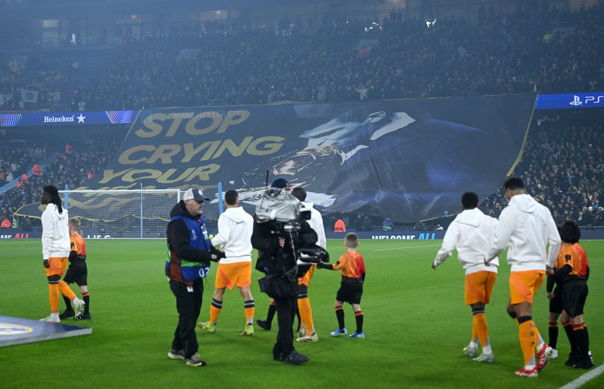 MANCHESTER, ENGLAND - FEBRUARY 11: Fans of Manchester City display a tifo which reads 'Stop crying your heart out' which includes a picture of Rodri of Manchester City kissing the Ballon d'or trophy prior to the UEFA Champions League 2024/25 League Knockout Play-off first leg match between Manchester City and Real Madrid C.F. at Manchester City Stadium on February 11, 2025 in Manchester, England. (Photo by Michael Regan/Getty Images).