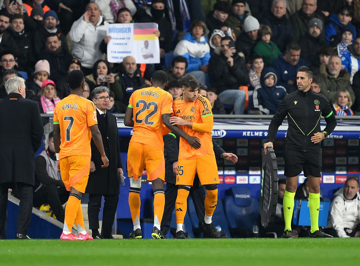 BARCELONA, SPAIN - FEBRUARY 01: Antonio Rüdiger of Real Madrid is embraced by Raul Asencio as he leaves the pitch following medical treatment after picking up an injury during the LaLiga match between RCD Espanyol de Barcelona and Real Madrid CF at RCDE Stadium on February 01, 2025 in Barcelona, Spain. (Photo by David Ramos/Getty Images)