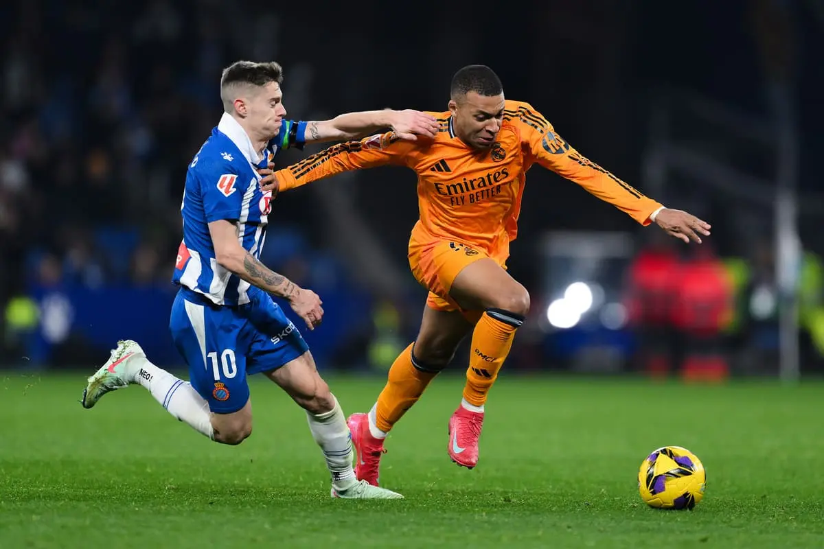 BARCELONA, SPAIN - FEBRUARY 01: Kylian Mbappe of Real Madrid is challenged by Pol Lozano of RCD Espanyol during the LaLiga match between RCD Espanyol de Barcelona and Real Madrid CF at RCDE Stadium on February 01, 2025 in Barcelona, Spain. (Photo by David Ramos/Getty Images).
