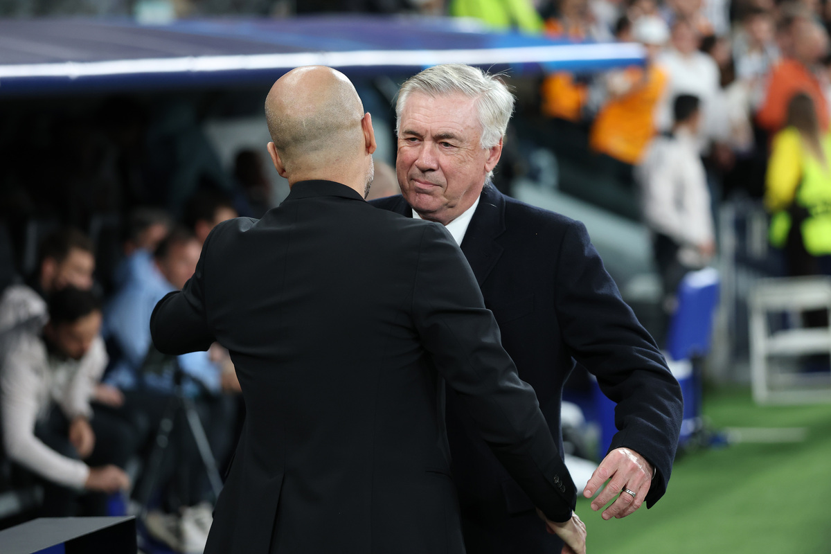 MADRID, SPAIN - FEBRUARY 19: Pep Guardiola, Manager of Manchester City, embraces Carlo Ancelotti, Head Coach of Real Madrid, prior to the UEFA Champions League 2024/25 League Knockout Play-off second leg match between Real Madrid C.F. and Manchester City at Santiago