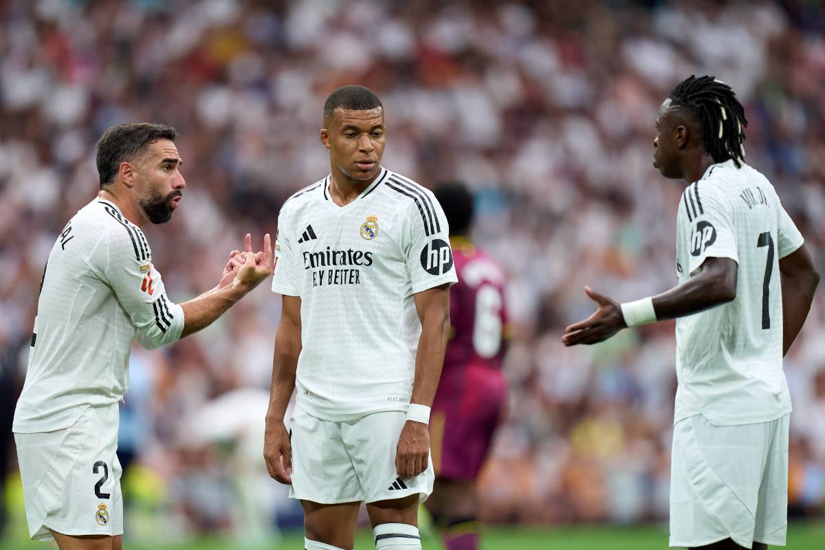 MADRID, SPAIN - AUGUST 25: Daniel Carvajal of Real Madrid interacts with his teammates Kylian Mbappe and Vinicius Junior during the La Liga match between Real Madrid CF and Real Valladolid CF at Estadio Santiago Bernabeu on August 25, 2024 in Madrid, Spain. (Photo by Angel Martinez/Getty Images)