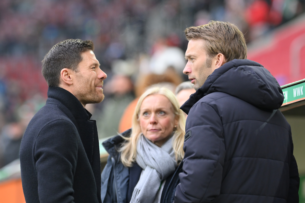 AUGSBURG, GERMANY - JANUARY 13: Head coach Xabi Alonso and sporting director Simon Rolfes of Bayer Leverkusen talk prior to the Bundesliga match between FC Augsburg and Bayer 04 Leverkusen at WWK-Arena on January 13, 2024 in Augsburg, Germany. (Photo by Sebastian Widmann/Getty Images)