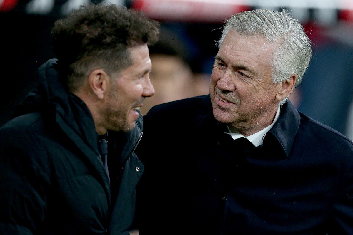 MADRID, SPAIN - FEBRUARY 25: Carlo Ancelotti, Head Coach of Real Madrid, interacts with Diego Simeone, Manager of Atletico Madrid, prior to the LaLiga Santander match between Real Madrid CF and Atletico de Madrid at Estadio Santiago Bernabeu on February 25, 2023 in Madrid, Spain. (Photo by Florencia Tan Jun/Getty Images)