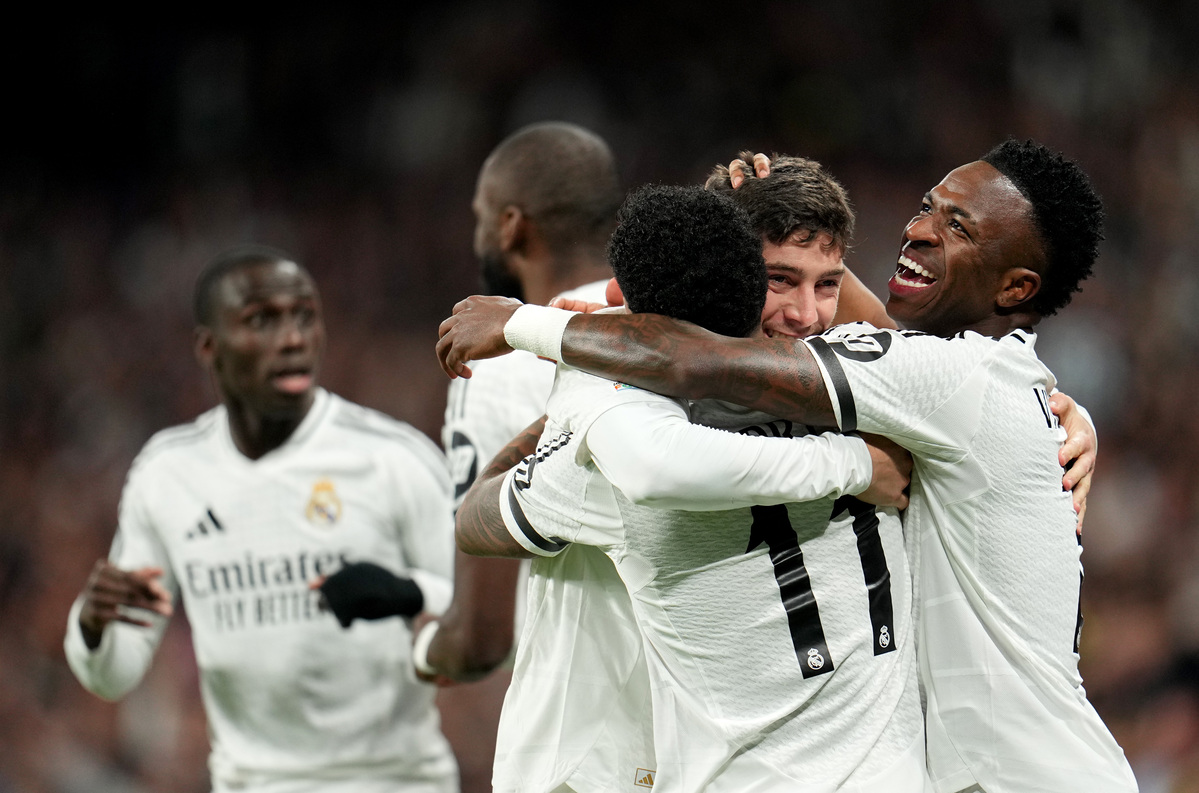 MADRID, SPAIN - MARCH 04: Rodrygo of Real Madrid celebrates scoring his team's first goal with teammates Vinicius Junior and Federico Valverde during the UEFA Champions League 2024/25 Round of 16 first leg match between Real Madrid C.F. and Atletico de Madrid at Santiago Bernabeu Stadium on March 04, 2025 in Madrid, Spain. (Photo by Aitor Alcalde/Getty Images) MADRID, SPAIN - MARCH 04: Rodrygo of Real Madrid celebrates scoring his team's first goal with teammates Vinicius Junior and Federico Valverde during the UEFA Champions League 2024/25 Round of 16 first leg match between Real Madrid C.F. and Atletico de Madrid at Santiago Bernabeu Stadium on March 04, 2025 in Madrid, Spain. (Photo by Aitor Alcalde/Getty Images)