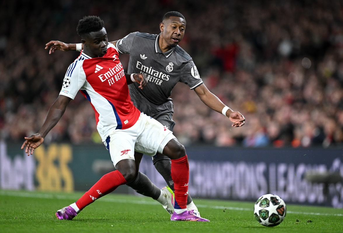 LONDON, ENGLAND - APRIL 08: David Alaba of Real Madrid is tackled by Bukayo Saka of Arsenal during the UEFA Champions League 2024/25 Quarter Final First Leg match between Arsenal FC and Real Madrid C.F. at Arsenal Stadium on April 08, 2025 in London, England. (Photo by Justin Setterfield/Getty Images)