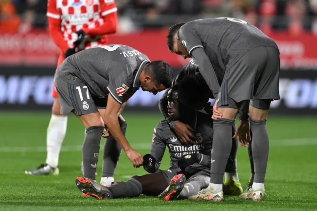 GIRONA, SPAIN - DECEMBER 07: Ferland Mendy of Real Madrid is consoled by Lucas Vazquez and Federico Valverde after picking up an injury during the LaLiga match between Girona FC and Real Madrid CF at Montilivi Stadium on December 07, 2024 in Girona, Spain. (Photo by David Ramos/Getty Images)