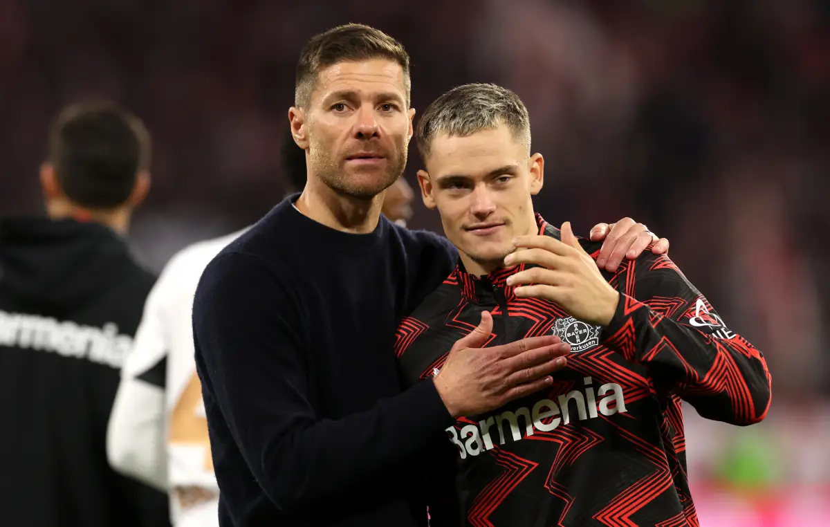 MUNICH, GERMANY - SEPTEMBER 28: Xabi Alonso, Head Coach of Bayer 04 Leverkusen, embraces Florian Wirtz of Bayer 04 Leverkusen a full-time following the team's draw in the Bundesliga match between FC Bayern München and Bayer 04 Leverkusen at Allianz Arena on September 28, 2024 in Munich, Germany. (Photo by Alexander Hassenstein/Getty Images)