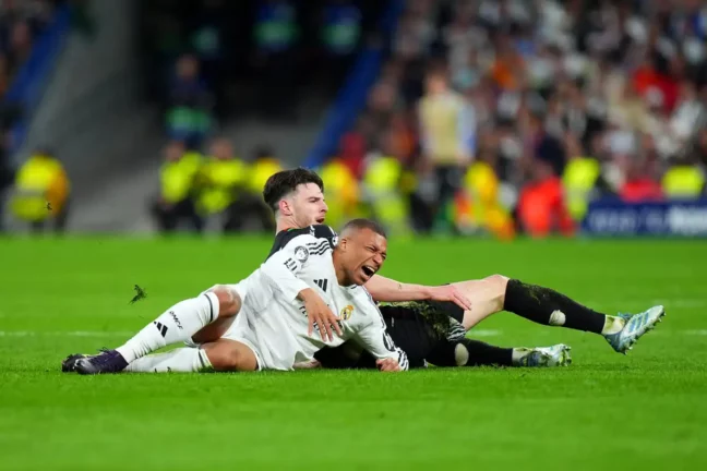 MADRID, SPAIN - APRIL 16: Kylian Mbappe of Real Madrid reacts after battling for possession with Declan Rice of Arsenal during the UEFA Champions League 2024/25 Quarter Final Second Leg match between Real Madrid C.F. and Arsenal FC at Estadio Santiago Bernabeu on April 16, 2025 in Madrid, Spain. (Photo by Angel Martinez/Getty Images)