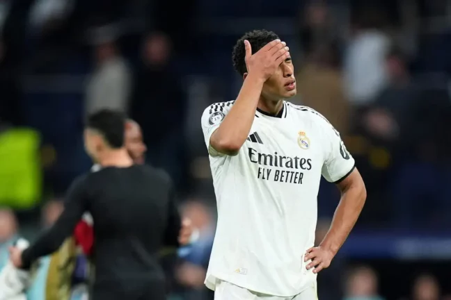 MADRID, SPAIN - APRIL 16: Jude Bellingham of Real Madrid looks dejected after the team's defeat in the UEFA Champions League 2024/25 Quarter Final Second Leg match between Real Madrid C.F. and Arsenal FC at Estadio Santiago Bernabeu on April 16, 2025 in Madrid, Spain. (Photo by Angel Martinez/Getty Images)