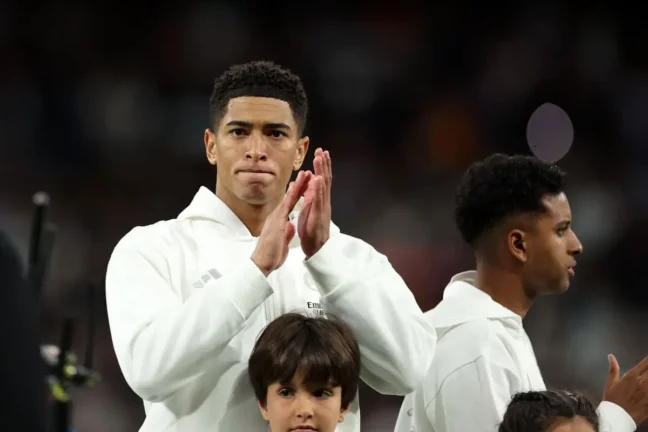 MADRID, SPAIN - APRIL 20: Jude Bellingham of Real Madrid applauds the fans as the teams line up prior to kick-off ahead of the LaLiga match between Real Madrid CF and Athletic Club at Estadio Santiago Bernabeu on April 20, 2025 in Madrid, Spain. (Photo by Florencia Tan Jun/Getty Images)