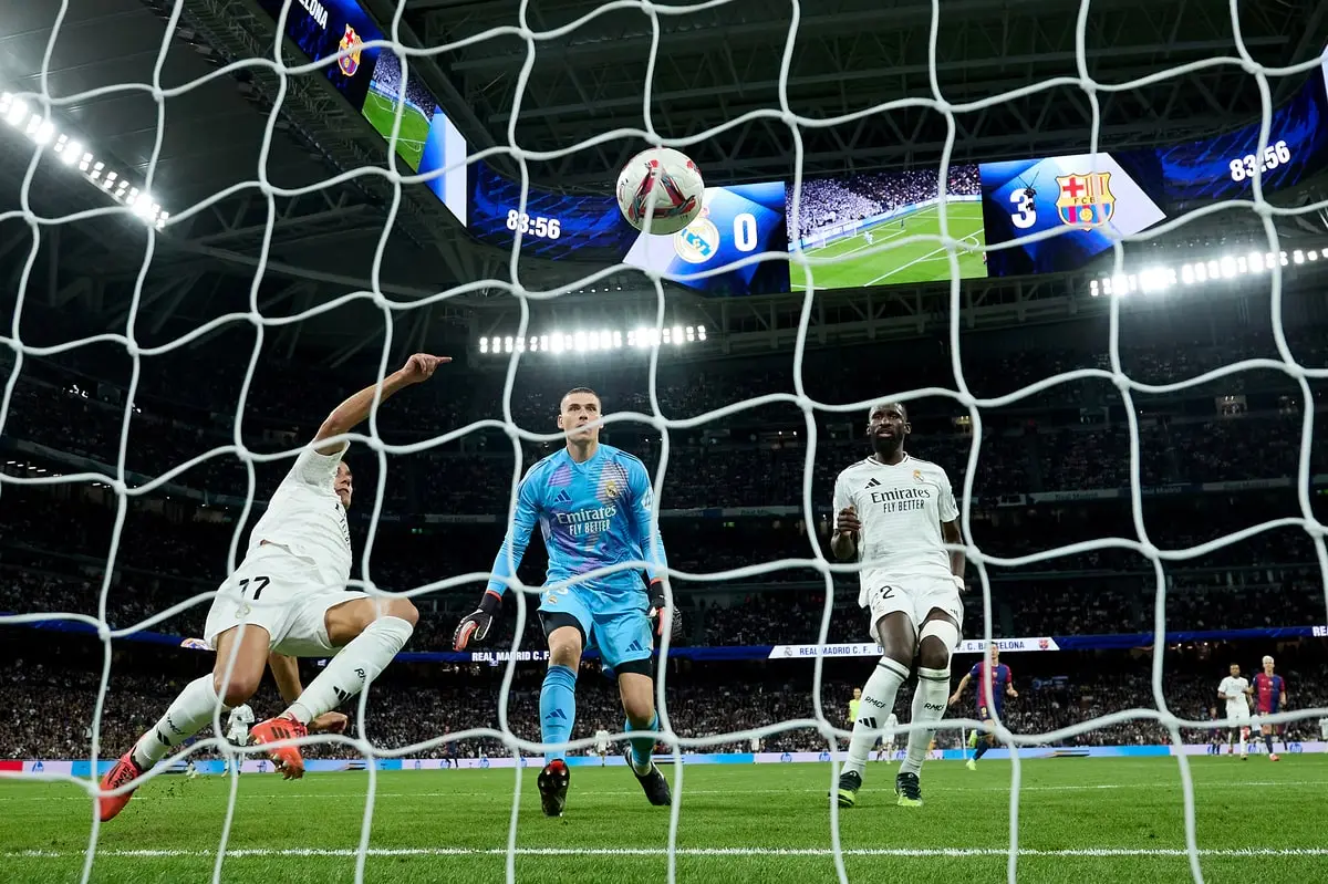 MADRID, SPAIN - OCTOBER 26: Lucas Vazquez of Real Madrid fails to make a save as teammates Andriy Lunin and Antonio Ruediger look on, as Raphinha of FC Barcelona (not pictured) scores his team's fourth goal during the LaLiga match between Real Madrid CF and FC Barcelona at Estadio Santiago Bernabeu on October 26, 2024 in Madrid, Spain. (Photo by Angel Martinez/Getty Images)
