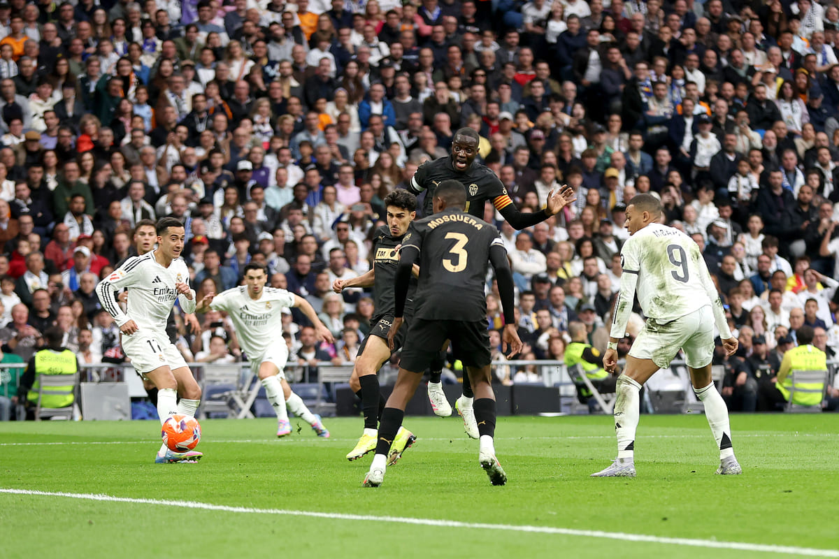 MADRID, SPAIN - APRIL 05: Mouctar Diakhaby of Valencia CF scores an own goal for Real Madrid's first goal of the match during the LaLiga match between Real Madrid CF and Valencia CF at Estadio Santiago Bernabeu on April 05, 2025 in Madrid, Spain. (Photo by Florencia Tan Jun/Getty Images)