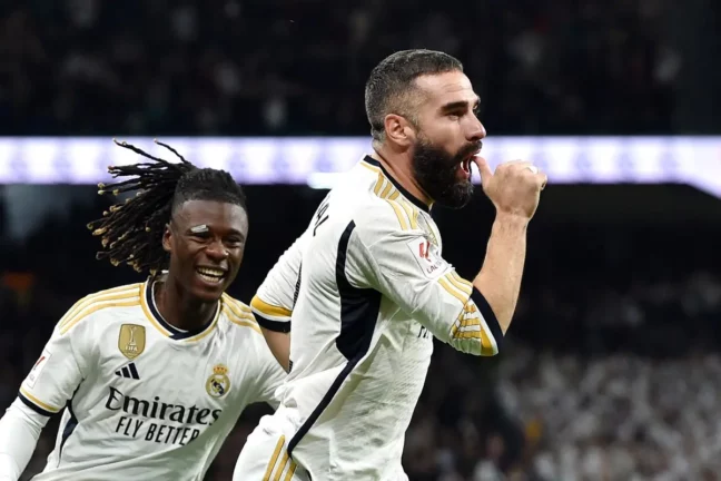 MADRID, SPAIN - NOVEMBER 11: Daniel Carvajal of Real Madrid (R) celebrates with teammate Eduardo Camavinga after scoring the team's first goal during the LaLiga EA Sports match between Real Madrid CF and Valencia CF at Estadio Santiago Bernabeu on November 11, 2023 in Madrid, Spain. (Photo by Denis Doyle/Getty Images)