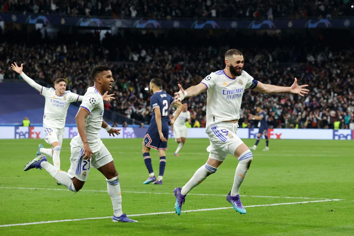 MADRID, SPAIN - MARCH 09: Karim Benzema of Real Madrid celebrates with teammate Rodrygo after scoring their team's third goal and his hat-trick during the UEFA Champions League Round Of Sixteen Leg Two match between Real Madrid and Paris Saint-Germain at Estadio Santiago Bernabeu on March 09, 2022 in Madrid, Spain. (Photo by Gonzalo Arroyo Moreno/Getty Images)