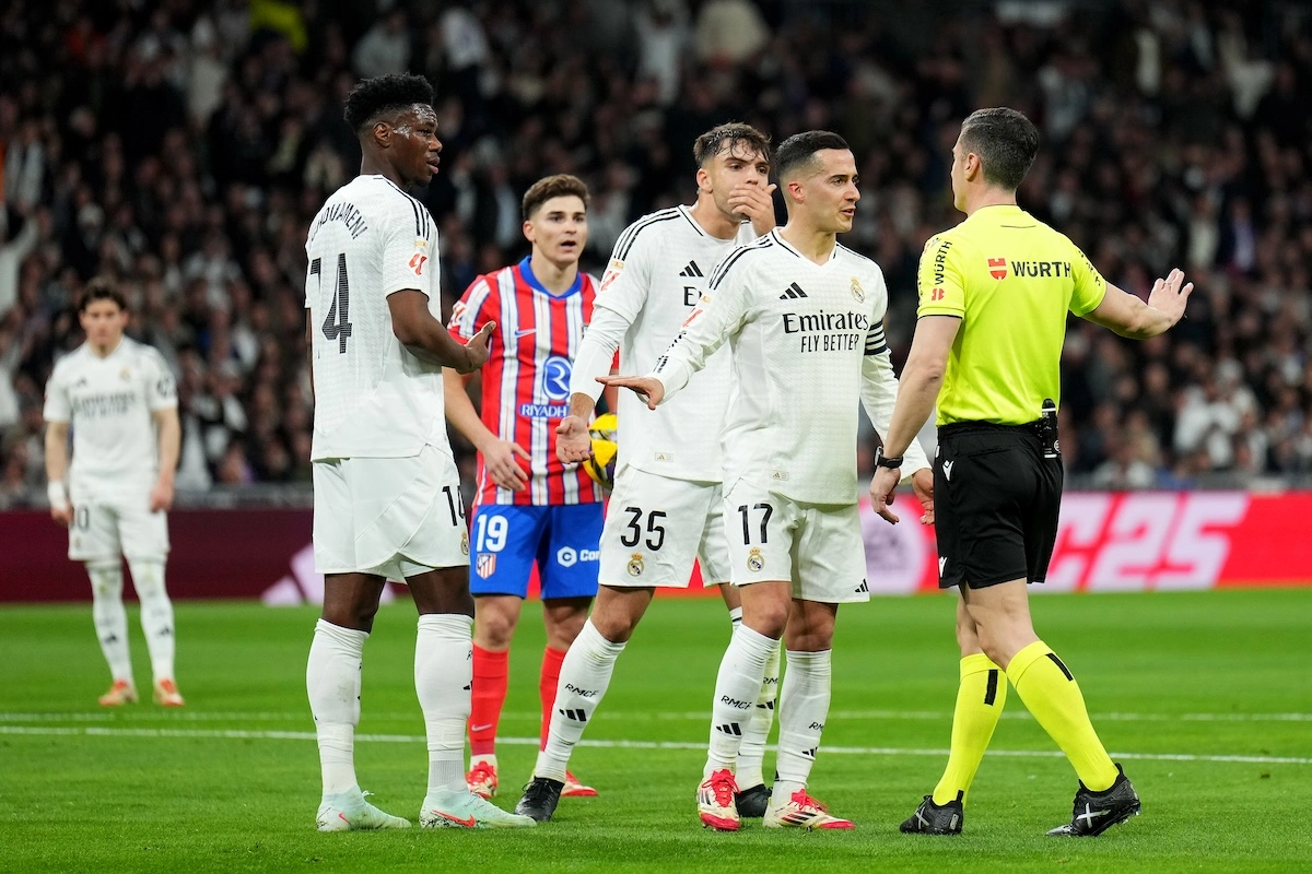 MADRID, SPAIN - FEBRUARY 08: Aurelien Tchouameni, Raul Asencio and Lucas Vazquez of Real Madrid react towards Referee Cesar Soto Grado during the LaLiga match between Real Madrid CF and Atletico de Madrid at Estadio Santiago Bernabeu on February 08, 2025 in Madrid, Spain. (Photo by Angel Martinez/Getty Images)