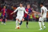 SEVILLE, SPAIN - APRIL 26: Raul Asencio of Real Madrid is challenged by Dani Olmo of FC Barcelona during the Copa del Rey Final match between FC Barcelona and Real Madrid at Estadio de La Cartuja on April 26, 2025 in Seville, Spain. (Photo by Fran Santiago/Getty Images)