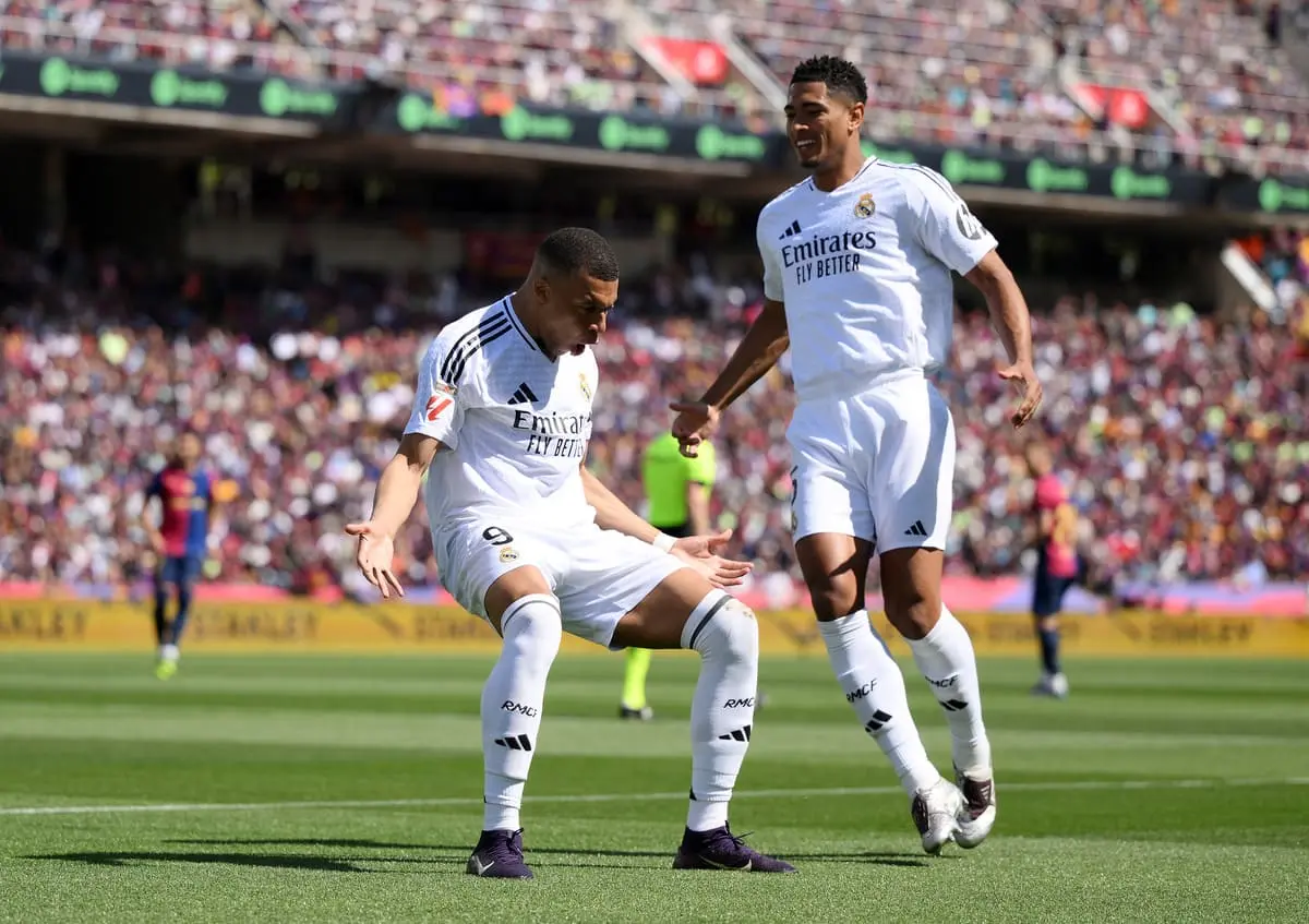 BARCELONA, SPAIN - MAY 11: Kylian Mbappe of Real Madrid celebrates scoring his team's first goal with teammate Jude Bellingham during the LaLiga match between FC Barcelona and Real Madrid CF at Estadi Olimpic Lluis Companys on May 11, 2025 in Barcelona, Spain. (Photo by David Ramos/Getty Images).