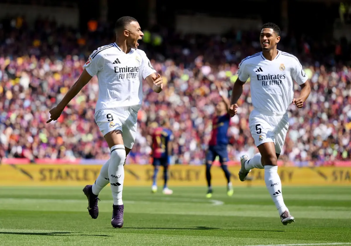 BARCELONA, SPAIN - MAY 11: Kylian Mbappe of Real Madrid celebrates scoring his team's first goal with teammate Jude Bellingham during the LaLiga match between FC Barcelona and Real Madrid CF at Estadi Olimpic Lluis Companys on May 11, 2025 in Barcelona, Spain. (Photo by David Ramos/Getty Images).