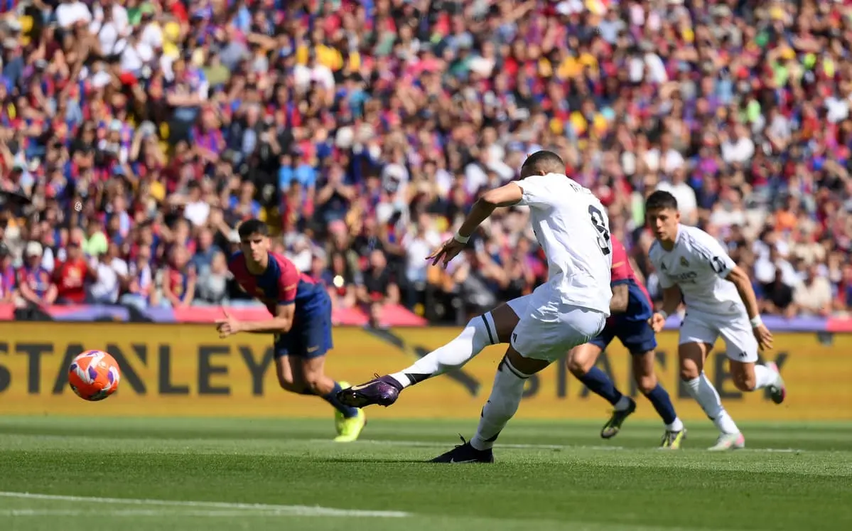 BARCELONA, SPAIN - MAY 11: Kylian Mbappe of Real Madrid scores his team's first goal from the penalty spot after being fouled by Wojciech Szczesny of FC Barcelona (not pictured) during the LaLiga match between FC Barcelona and Real Madrid CF at Estadi Olimpic Lluis Companys on May 11, 2025 in Barcelona, Spain. (Photo by David Ramos/Getty Images)